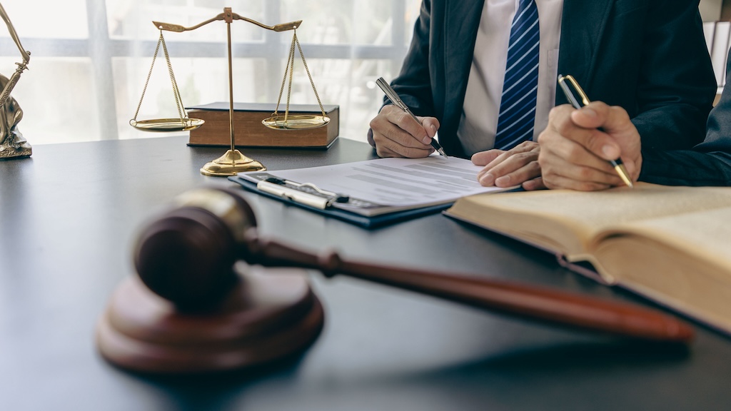 legal advisory office Lawyer in with hammer, symbol of justice Lawyer businessman working or reading law book in workplace for lawyer consulting concept